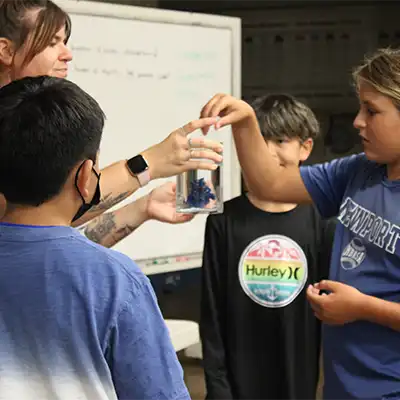 Guest instructor sharing her knowledge of coral with campers