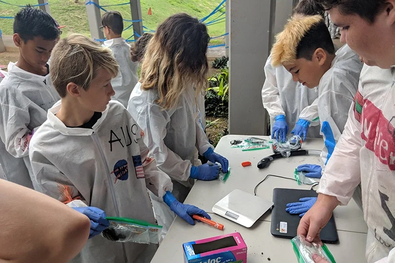 Campers simulate collecting soil samples in space